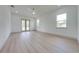 This bright bedroom features neutral walls, a ceiling fan, two windows, and double glass doors to the yard at 4266 La Salle Ave, St Cloud, FL 34772