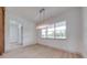 Bright dining room with large window and modern chandelier lighting, adjacent to hallway at 4266 La Salle Ave, St Cloud, FL 34772