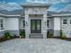 Elegant entrance with double doors, detailed stonework, and manicured landscaping at 4266 La Salle Ave, St Cloud, FL 34772