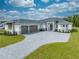 Beautiful home with a three-car garage, paver driveway, and manicured lawn at 4266 La Salle Ave, St Cloud, FL 34772