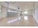 Three-car garage with an epoxy floor, windows, and an insulated garage door at 4266 La Salle Ave, St Cloud, FL 34772