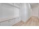 This hallway features bench seating, storage and light wood-look flooring at 4266 La Salle Ave, St Cloud, FL 34772