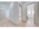 Hallway view to bathroom with tub, showcasing the house's bright, open design and access to other rooms at 4266 La Salle Ave, St Cloud, FL 34772