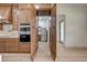 Well-appointed kitchen features custom cabinets, backsplash, stainless appliances, and access to a walk-in pantry at 4266 La Salle Ave, St Cloud, FL 34772