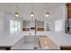 Bright, modern kitchen with farmhouse sink, gold faucet, and open layout into living area with fireplace at 4266 La Salle Ave, St Cloud, FL 34772