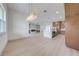 Open concept living room and kitchen with wood floors and a modern chandelier at 4266 La Salle Ave, St Cloud, FL 34772