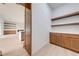 Walk-in pantry featuring custom wood cabinets and shelving, providing ample storage space at 4266 La Salle Ave, St Cloud, FL 34772