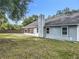 Exterior side view of the home with a spacious backyard at 4274 Meeting Pl, Sanford, FL 32773