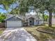 Charming single-story home featuring mature trees, well-maintained lawn, and attached two-car garage at 4274 Meeting Pl, Sanford, FL 32773