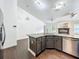 Open kitchen with granite counters, stainless appliances, and hardwood floors at 4274 Meeting Pl, Sanford, FL 32773