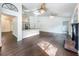 Open living room with hardwood floors, kitchen, fireplace, and lots of light at 4274 Meeting Pl, Sanford, FL 32773