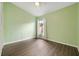 Empty bedroom with wood-look floors, a window and ceiling fan with light at 4398 Fox Hollow Cir, Casselberry, FL 32707