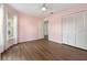 Bright bedroom featuring hardwood flooring, a ceiling fan, and a closet for storage at 4398 Fox Hollow Cir, Casselberry, FL 32707