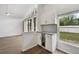 Butlers pantry featuring granite countertops, white cabinets, beverage fridge and natural lighting at 4398 Fox Hollow Cir, Casselberry, FL 32707