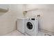 Laundry room with white washer and dryer and wire shelving at 4398 Fox Hollow Cir, Casselberry, FL 32707