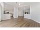 Open living space with wood-look floors and multiple entryways featuring architectural half-walls at 4398 Fox Hollow Cir, Casselberry, FL 32707