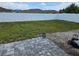 Fenced backyard with a grass lawn, patio, and gravel area offers a serene and private outdoor space at 4564 Orchard Grove Rd, St Cloud, FL 34772