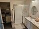 Bathroom featuring double sinks, a glass shower, and a walk in closet for ample storage space at 4564 Orchard Grove Rd, St Cloud, FL 34772