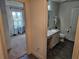 Bathroom featuring a vanity with storage, modern fixtures, and tile flooring adjacent to a bedroom at 4564 Orchard Grove Rd, St Cloud, FL 34772