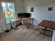 Bedroom features a desk, office chair, and large windows providing natural light for a productive workspace at 4564 Orchard Grove Rd, St Cloud, FL 34772