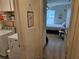Hallway featuring access to laundry room and bedroom with bright natural light and neutral tones at 4564 Orchard Grove Rd, St Cloud, FL 34772