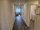 Inviting hallway leading to a bright living area, with stylish tile flooring and access to the laundry room at 4564 Orchard Grove Rd, St Cloud, FL 34772