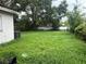 Spacious backyard with lush greenery and mature trees, offering a private outdoor space at 4631 America St, Orlando, FL 32811