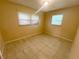 Bright bedroom featuring tiled flooring and abundant natural light at 4631 America St, Orlando, FL 32811