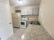 Kitchen featuring sleek countertops, neutral cabinets, and modern appliances at 4631 America St, Orlando, FL 32811