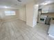 Open living room with neutral paint, and tile flooring, seamlessly connected to the kitchen at 4631 America St, Orlando, FL 32811
