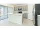 Kitchen with stainless steel appliances, island, and grey cabinets at 4917 Bluebell Ct, Lake Hamilton, FL 33851