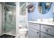 Well-lit bathroom features a walk-in shower and a vanity with double mirrors and ample storage at 6011 Country Walk Ln, Winter Haven, FL 33880
