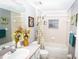 Bright bathroom featuring a shower-tub combo and floral accents creating a refreshing ambiance at 6011 Country Walk Ln, Winter Haven, FL 33880