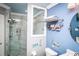 Stylish bathroom with a modern vanity, glass-enclosed shower, and blue accents at 6011 Country Walk Ln, Winter Haven, FL 33880