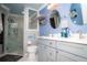 Modern bathroom featuring double sinks, marble countertops, and a glass-enclosed walk-in shower at 6011 Country Walk Ln, Winter Haven, FL 33880