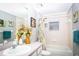 Bright bathroom featuring a vanity, a shower-tub combo with a decorative curtain, and stylish decor at 6011 Country Walk Ln, Winter Haven, FL 33880
