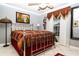 Well-lit bedroom with a comfortable bed, bright window, and decor in the corner at 6011 Country Walk Ln, Winter Haven, FL 33880
