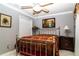 Comfortable bedroom with a metal frame bed, complemented by soft lighting and wall art at 6011 Country Walk Ln, Winter Haven, FL 33880