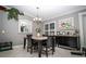 Cozy dining room featuring a modern chandelier, a decorative mirror, and a black buffet table with decor at 6011 Country Walk Ln, Winter Haven, FL 33880