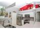 Bright kitchen featuring stainless steel appliances, a corner sink, white cabinets, and eye-catching decor at 6011 Country Walk Ln, Winter Haven, FL 33880