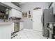 Bright kitchen featuring stainless steel appliances, a corner sink, white cabinets, and eye-catching decor at 6011 Country Walk Ln, Winter Haven, FL 33880