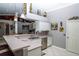 Bright kitchen featuring stainless steel appliances, white cabinets, a breakfast bar, and modern pendant lighting at 6011 Country Walk Ln, Winter Haven, FL 33880