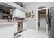 Bright kitchen featuring stainless steel appliances, a corner sink, white cabinets, and eye-catching decor at 6011 Country Walk Ln, Winter Haven, FL 33880