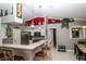 Bright kitchen featuring stainless steel appliances, white cabinets, a breakfast bar, and modern pendant lighting at 6011 Country Walk Ln, Winter Haven, FL 33880