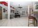 Open living space with tile flooring, natural light from large windows, and a built-in bar area at 6011 Country Walk Ln, Winter Haven, FL 33880