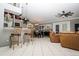 Open living space includes kitchen bar, dining area, and living area with leather furniture at 6011 Country Walk Ln, Winter Haven, FL 33880