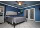 Spacious main bedroom featuring a ceiling fan, French doors and neutral decor at 6011 Country Walk Ln, Winter Haven, FL 33880