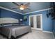 Bright main bedroom featuring a ceiling fan and access to the backyard through French doors at 6011 Country Walk Ln, Winter Haven, FL 33880