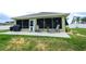 Covered patio with screened walls, patio furniture, and verdant planting beds at 6011 Country Walk Ln, Winter Haven, FL 33880