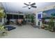 Relaxing covered patio with ceiling fans, patio furniture, and numerous plants at 6011 Country Walk Ln, Winter Haven, FL 33880